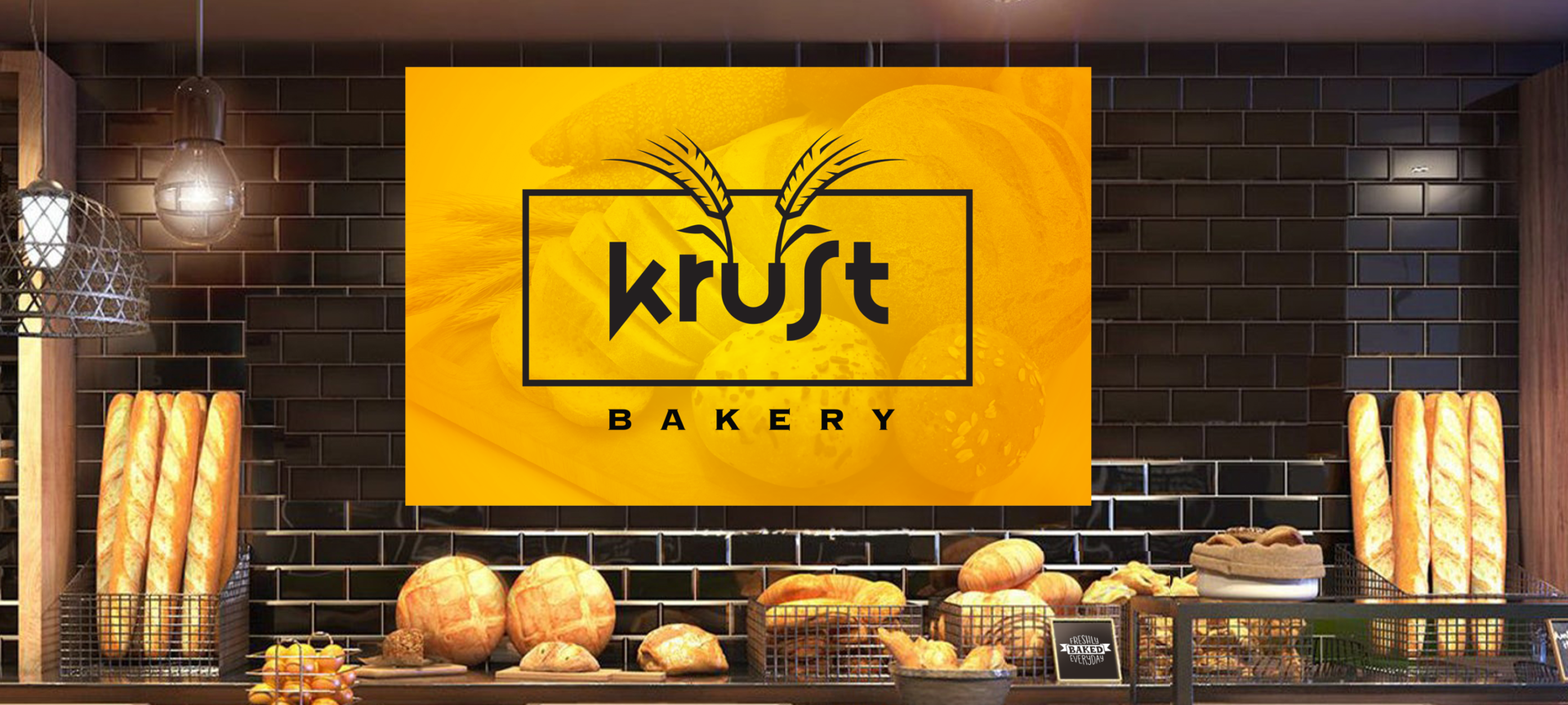 a behind the counter scene in a bakery with black tiles and baskets of freshly baked bread with a large golden duotone sign with the logo for Krust Bakery.